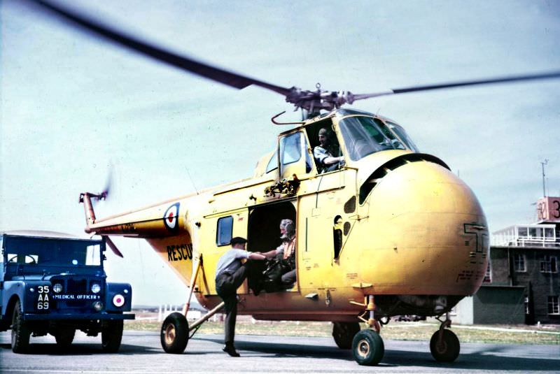 An RAF medical officer climbs aboard Westland Whirlwind HAR.2 XJ728 of ‘A’ Flight, No. 22 Squadron based at RAF St Mawgan, 1957