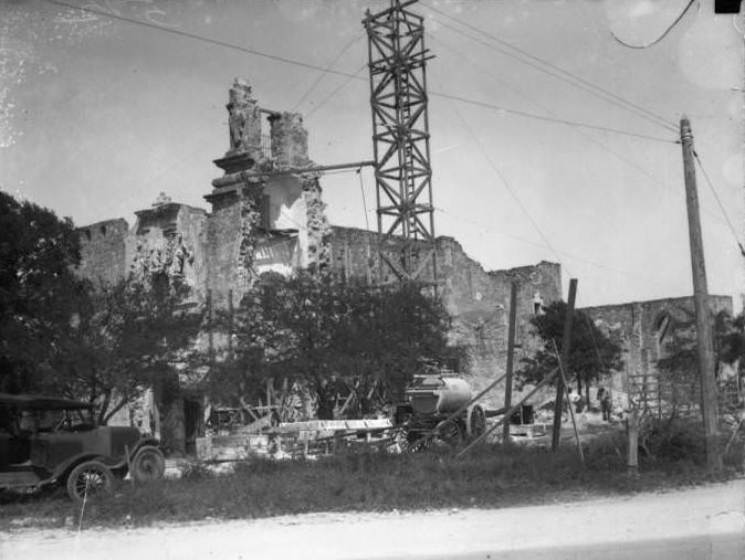 Exterior view of San Jose y San Miguel de Aguayo Mission during the restoration of the tower, 1928