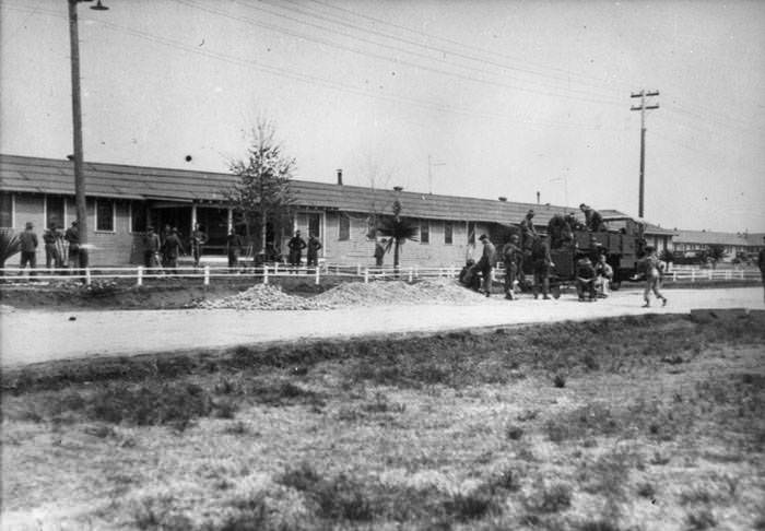 Men working in yard; others gathered around a truck, Brooks Field, 1923