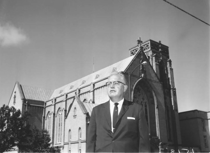 Portrait of Dr. R.E. Braulick in front of St. Johns Lutheran Church, 1925