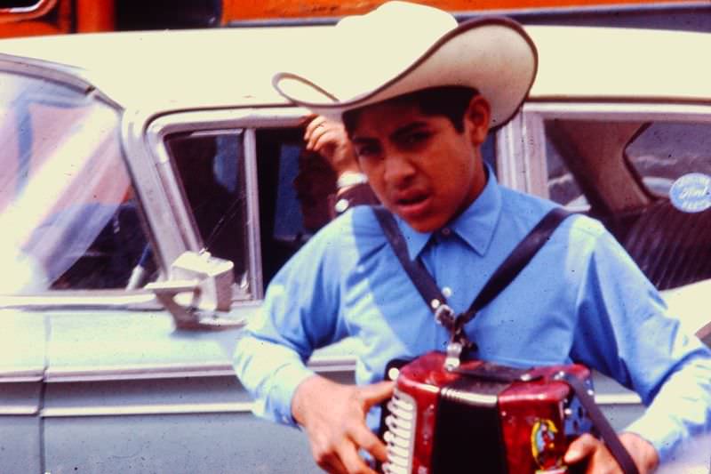 Young man getting ready for a performance with his accordian, Tijuana, 1971