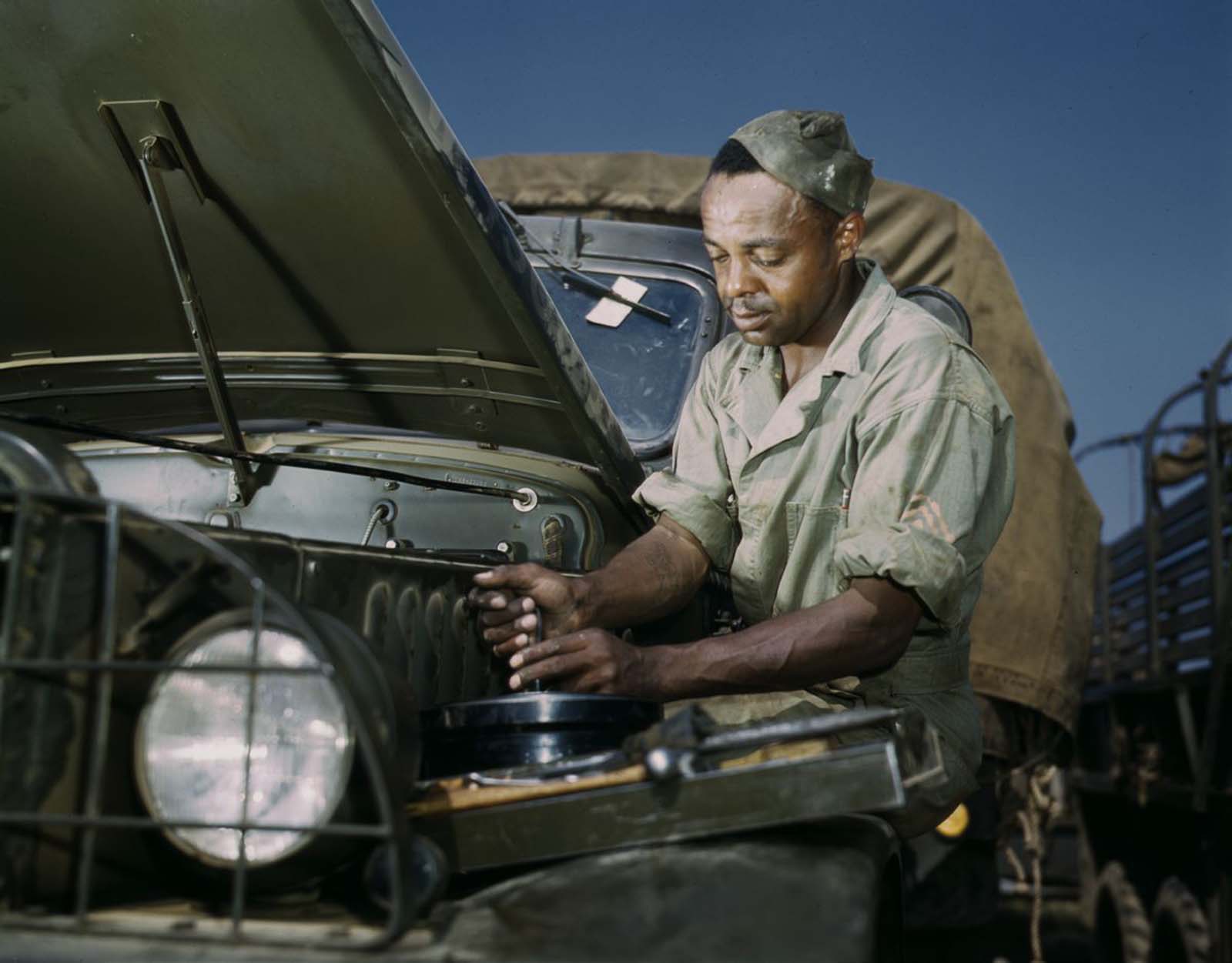 A mechanic works on a troop transport vehicle.