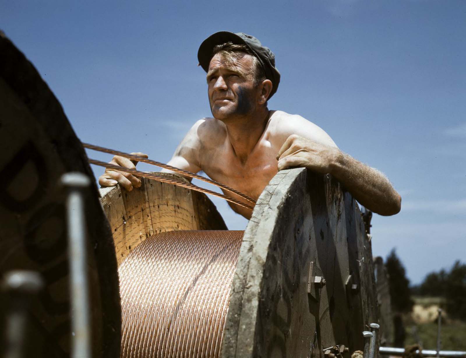 A construction worker helps build a new power line into the rapidly growing installation.