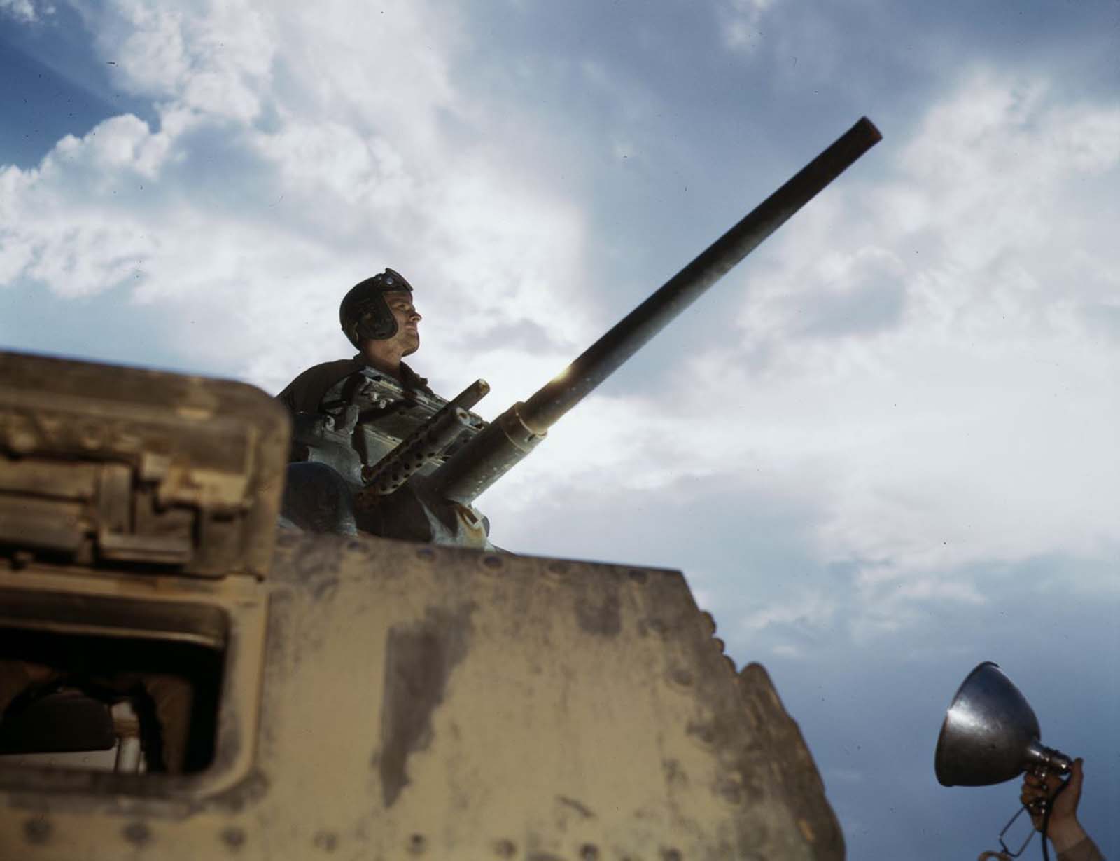 A tank commander poses for a flash-lit profile.