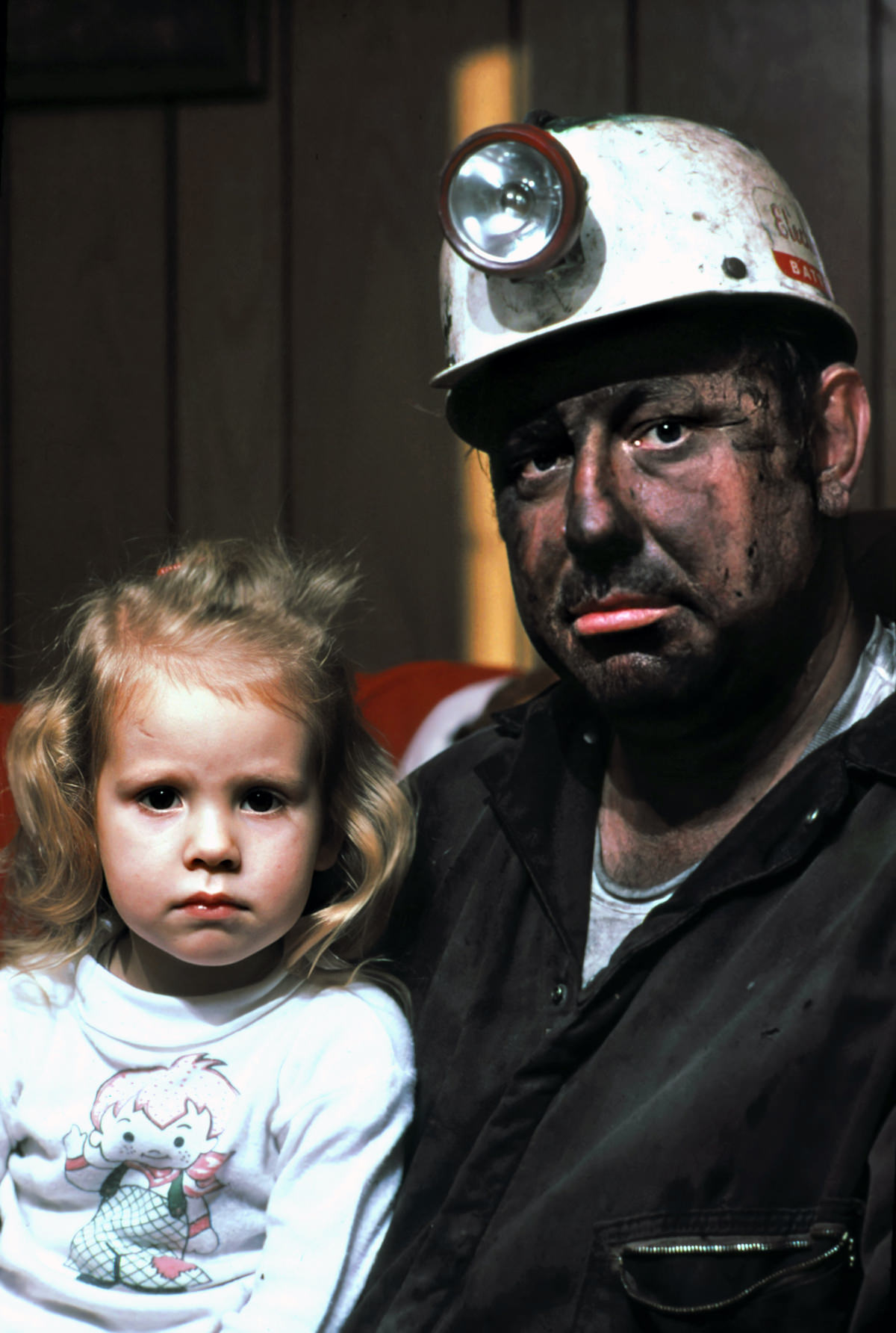 Miner Wayne Gipson, 39, with his daughter Tabitha, 3. He has just gotten home from his job as a conveyor belt operator in a non-union mine.