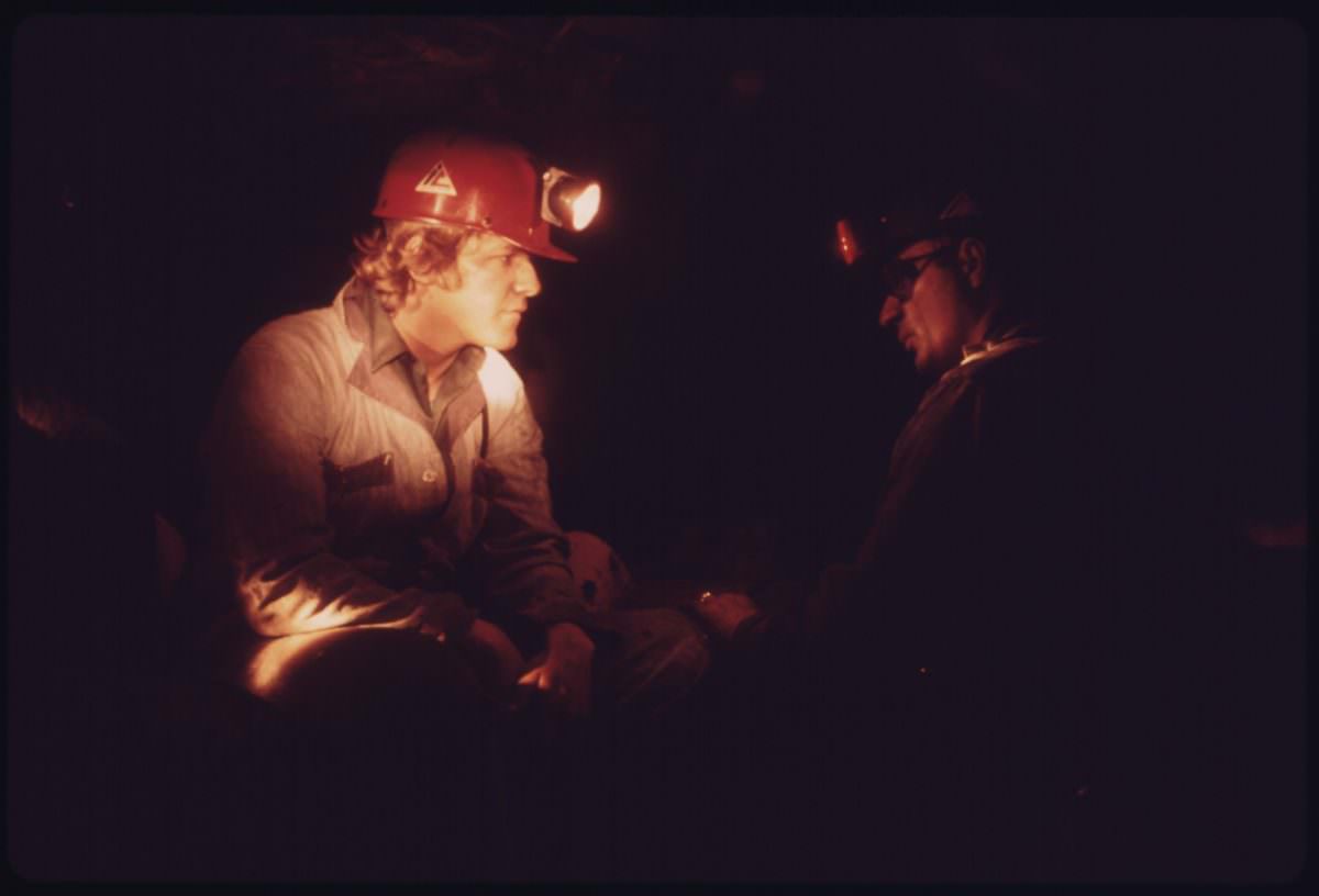 Veteran miner Harold Stanley, right, talks to a young miner who has come into the mine for the first time after 40 hours of classroom training.