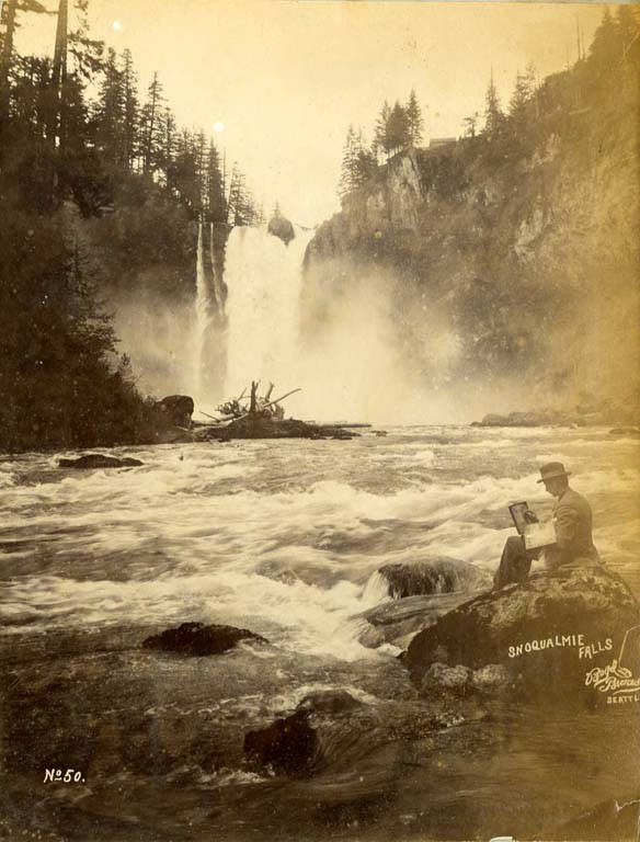 George Braas sketching on rock at the Snoqualmie Falls, Washington, 1889