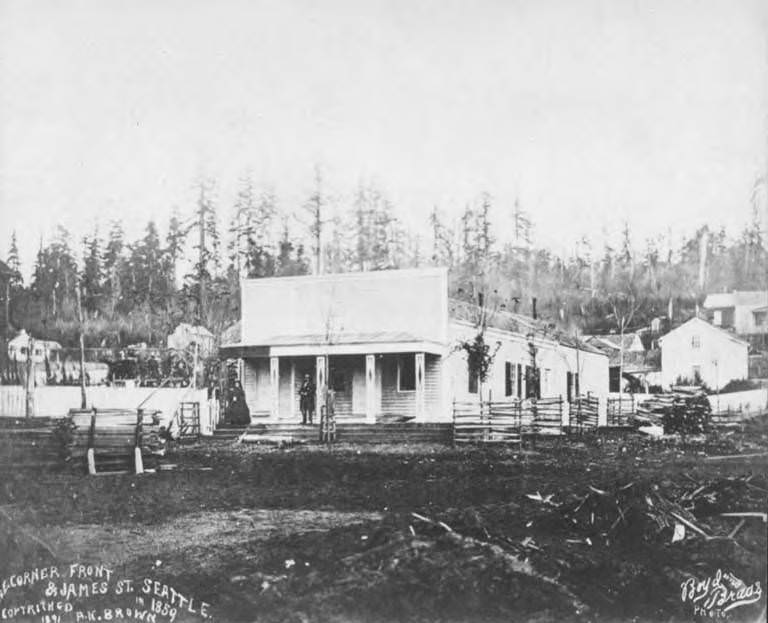 Northeast corner of Front and James St., Seattle, showing Henry L. and Sara Yesler on porch of their house, Seattle, 1859