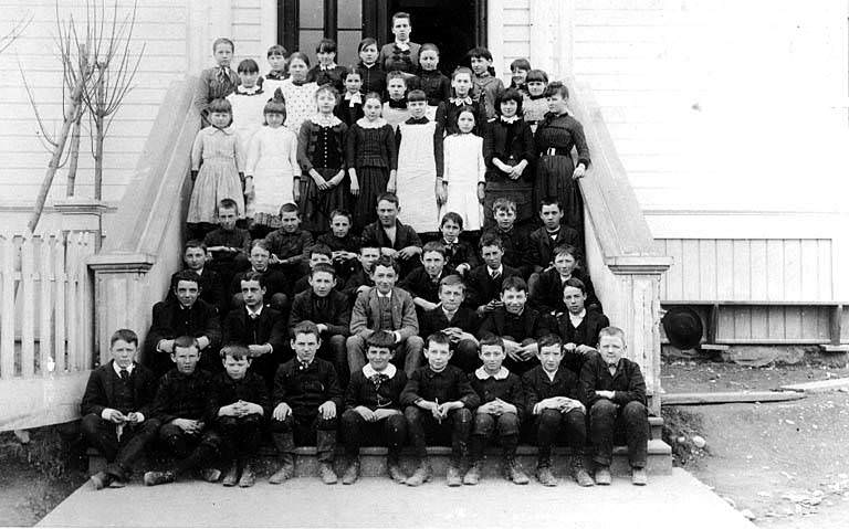 Central School, children and teachers posed on steps, 1870