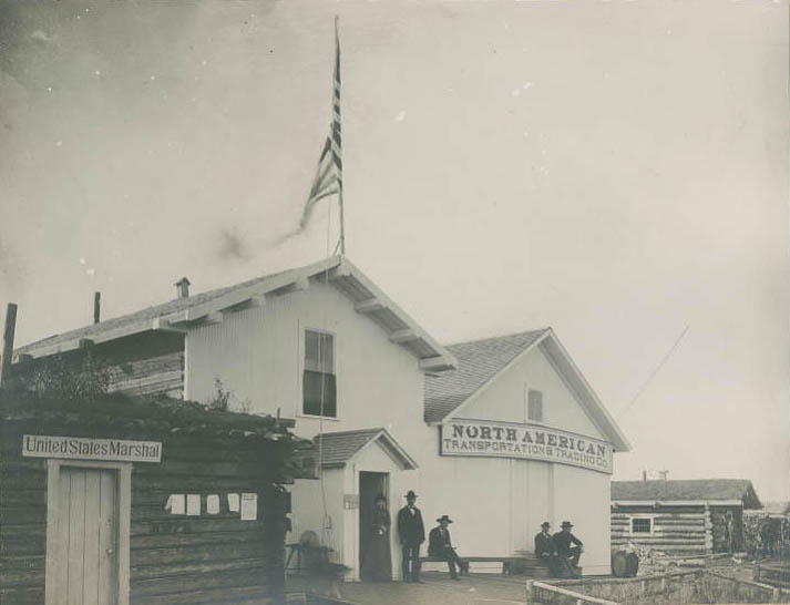 Group outside North American Transportation & Trading Company in Circle City, Alaska, 1899