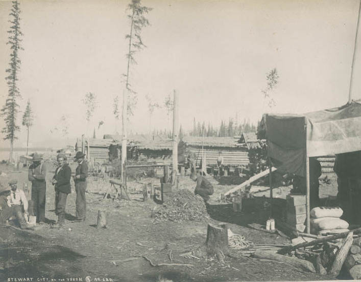 Men and log cabins at Stewart City, Yukon, 1899