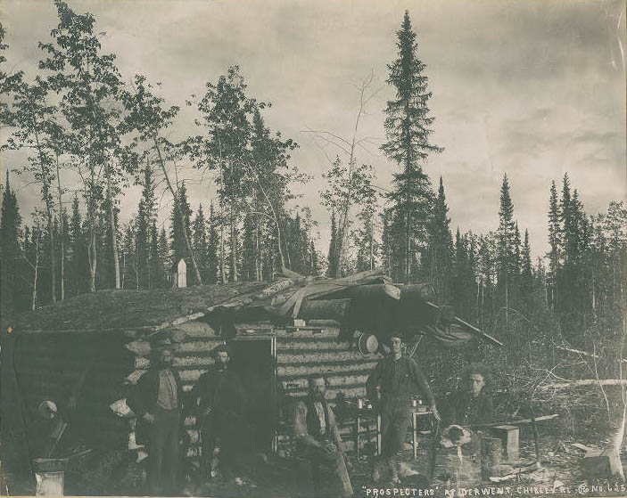 Prospectors and log cabin at Derwent, Alaska, 1899