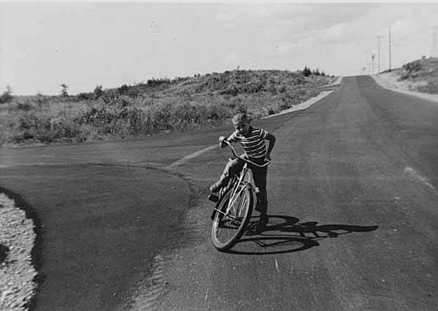 Craig Hook riding bike in Norwood Village, Bellevue, 1958