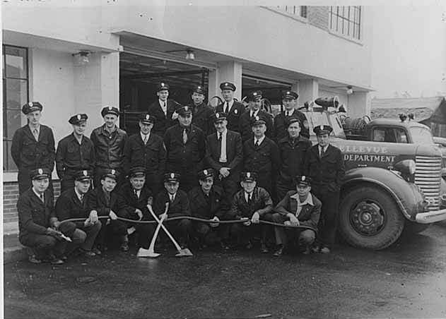 Firemen with truck at fire station, Bellevue, June 1947