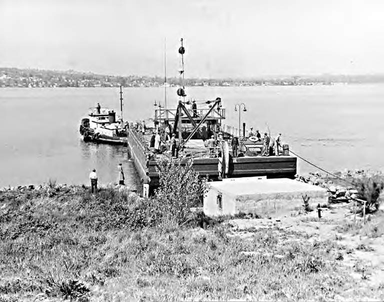 Cable laying operation during the laying of telephone cable across Lake Washington between Bellevue and Seattle using the barge TELEPHONE II, 1940s