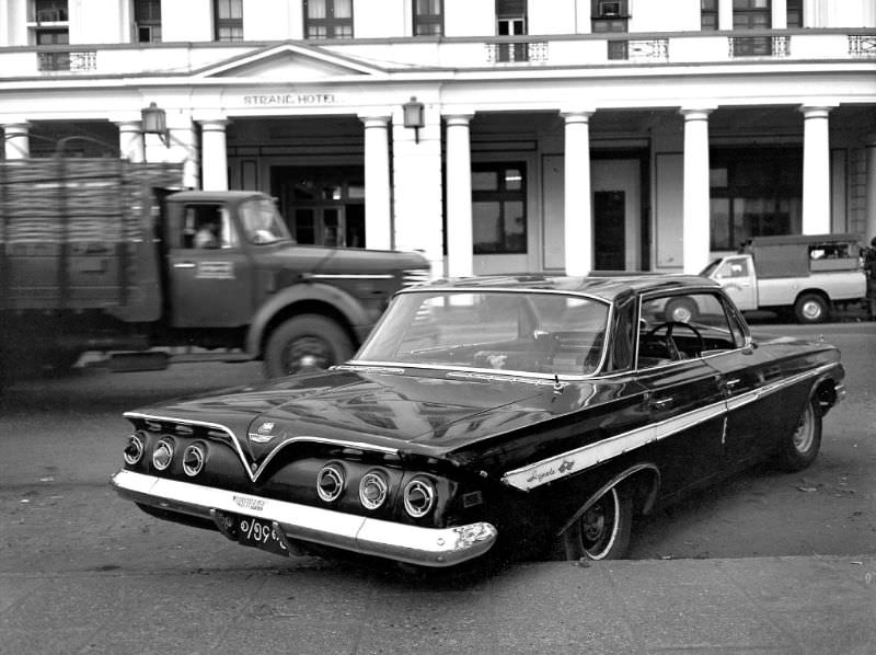 Rangoon. 1961 Chevrolet Impala hardtop with right-hand drive, parked in front of the Strand Hotel, Burma, 1986