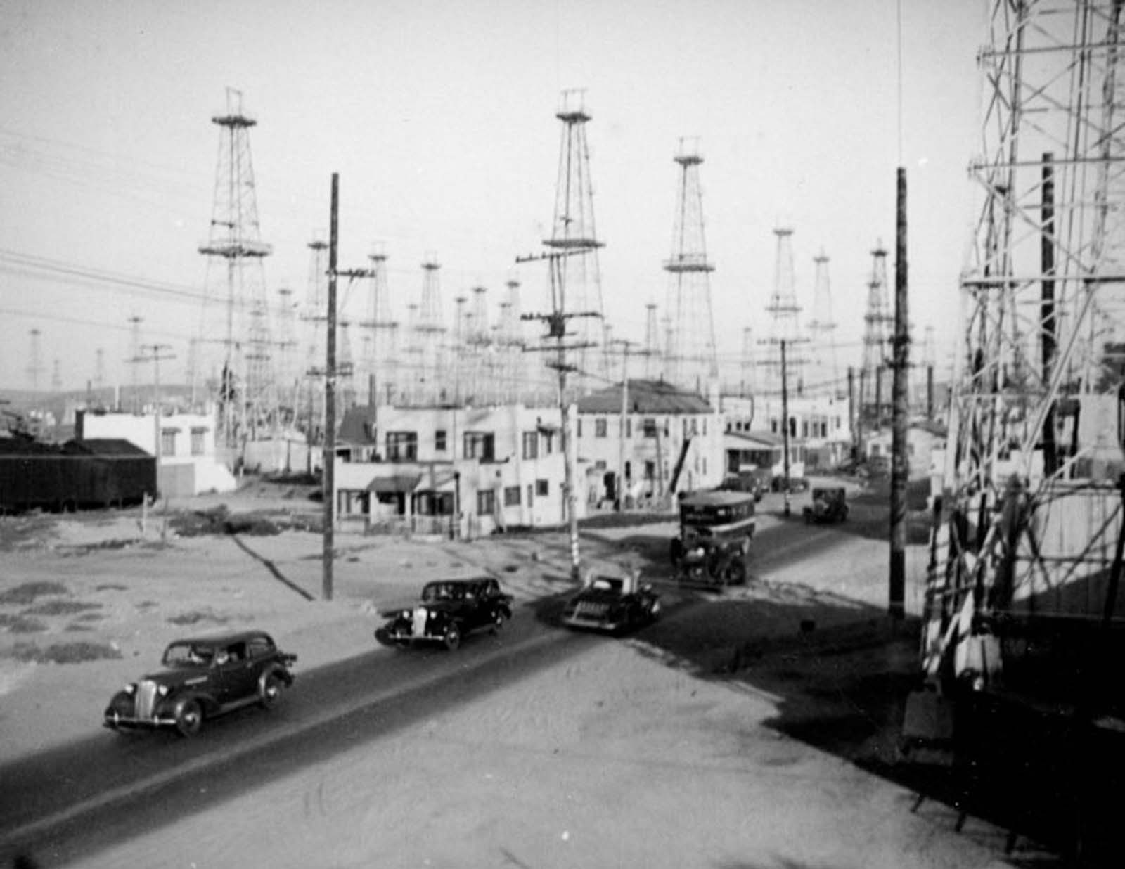 Cars travel through the Venice oilfield, 1937