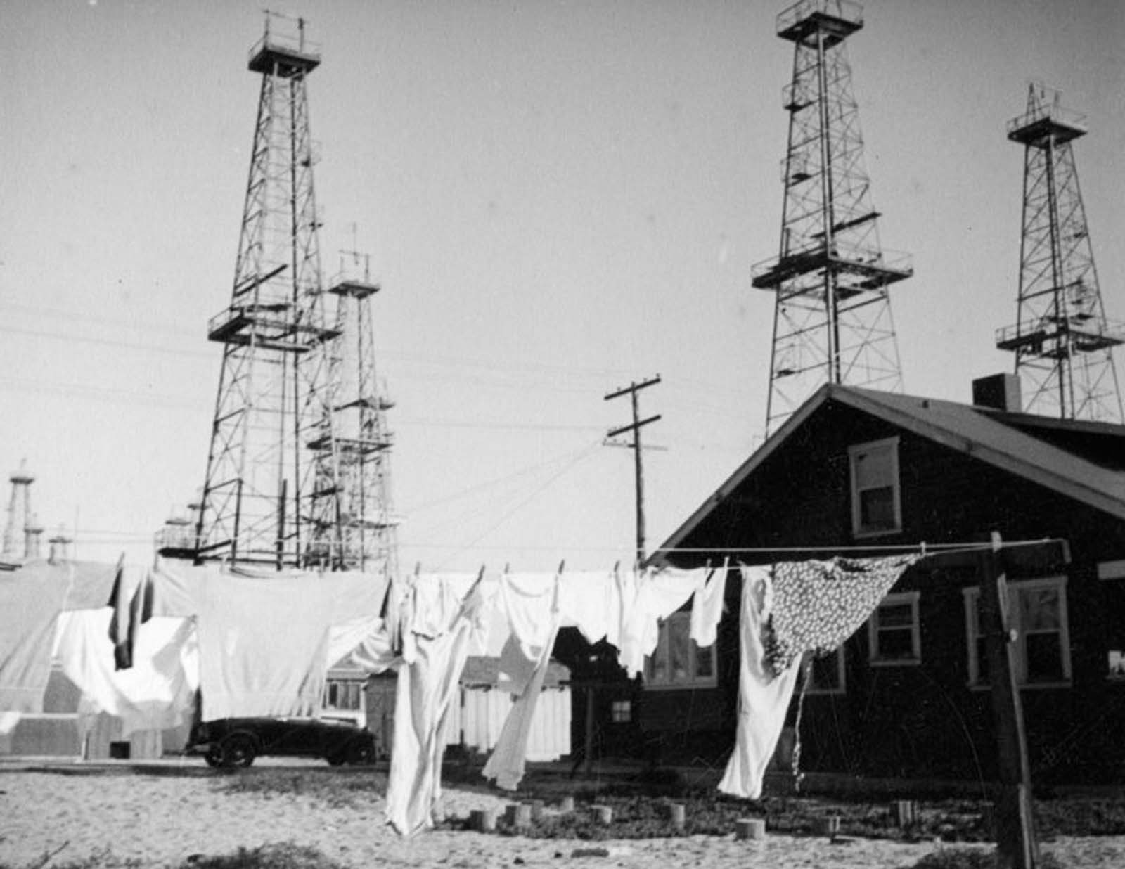 Laundry dries on a clothesline near the Venice oilfield