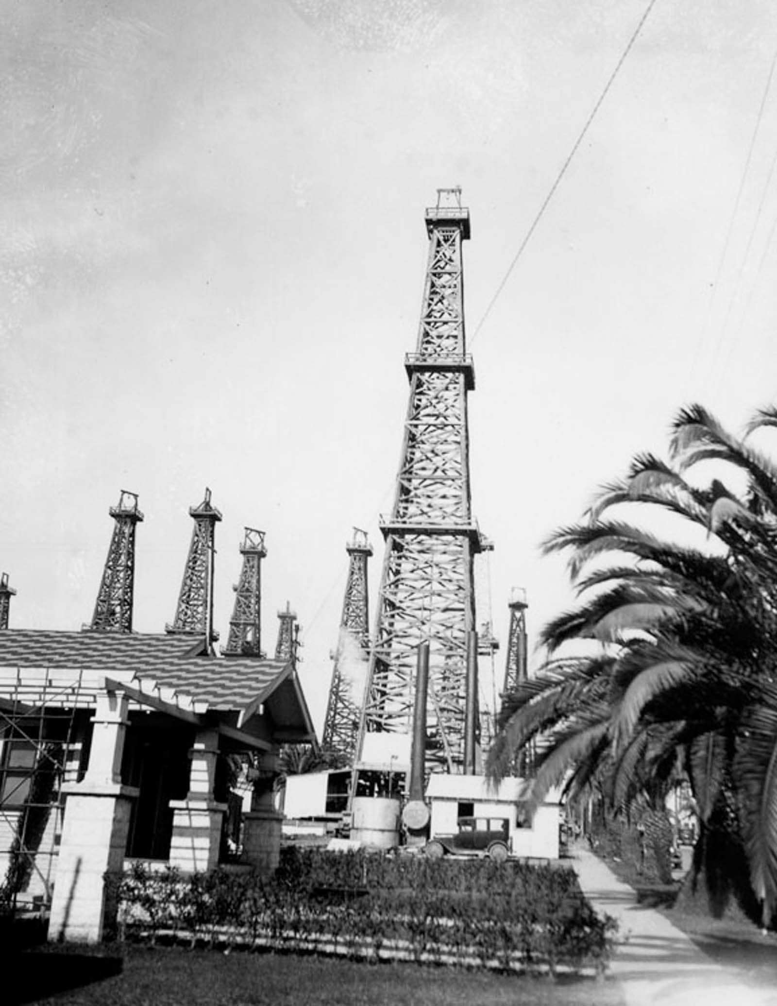 A Long Beach home with oil derricks nearby, 1929.