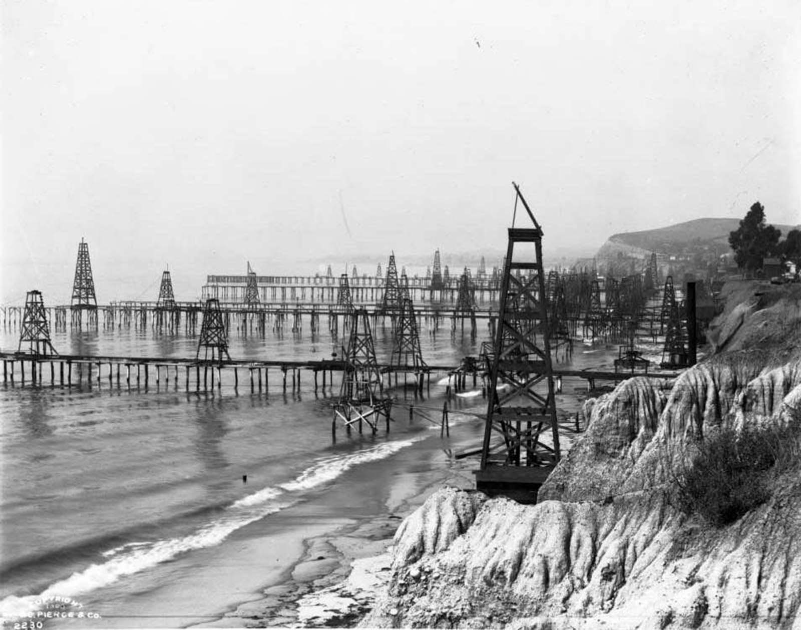 Oil derricks extending into the Pacific at Summerland Beach near Santa Barbara, 1903.