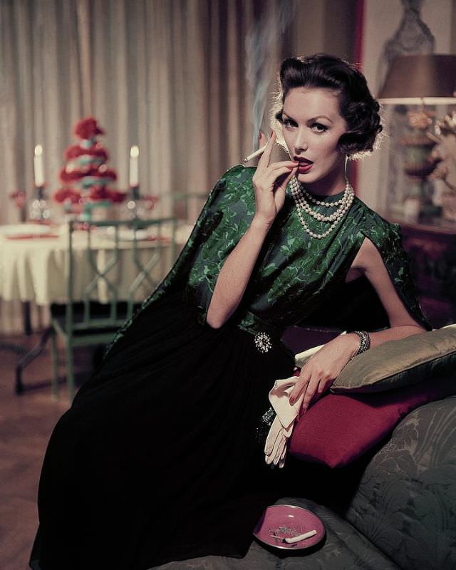 Lucinda Hollingsworth wearing a green and black floral print dress, December 1956