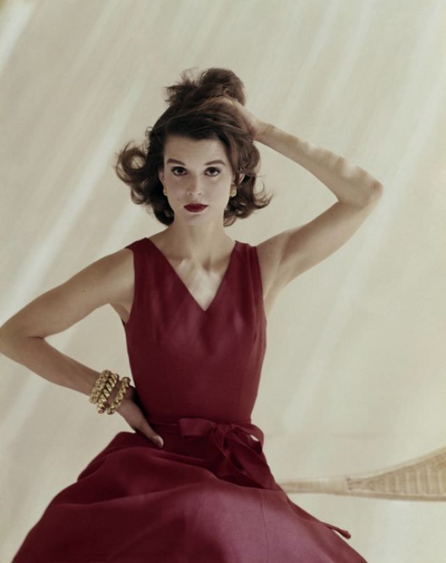 Model is wearing a red linen Anne Fogarty dress and jewelry by Tiffany & 1960