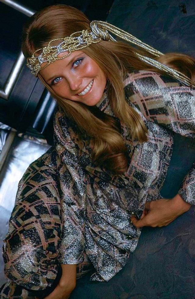 Cheryl Tiegs wearing a silver and gold belt as a headband by Myra Harding and a groovy Lurex smoking suit by Victor Joris, 1969