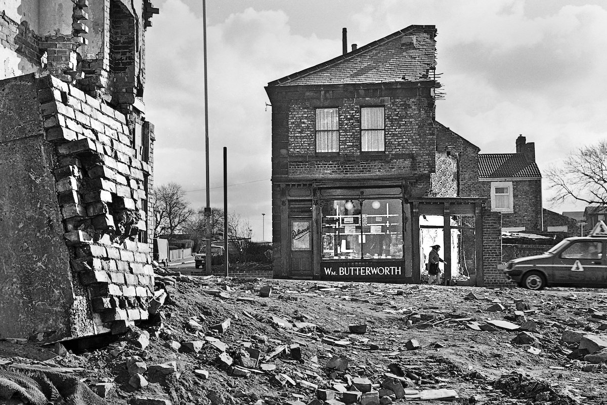 Wm Butterworth, butcher, is still open, even as the demolition goes on around him in 1982