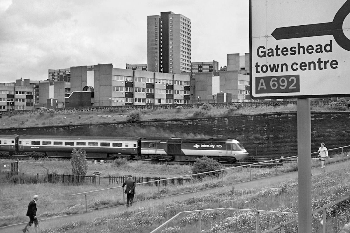 An InterCity 125 train heads south past St. Cuthberts Village in 1987.