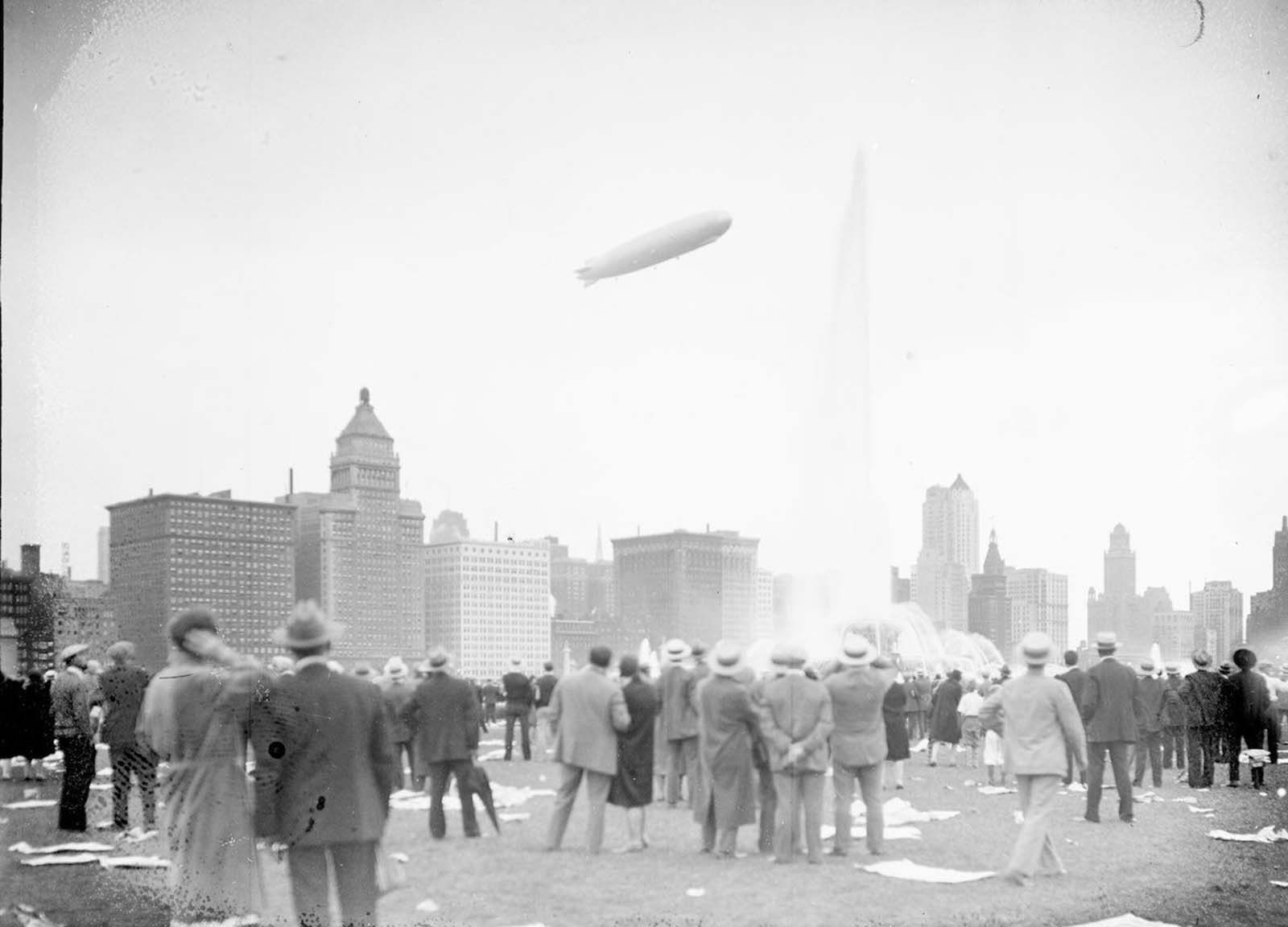 View of the Graf Zeppelin at an angle flying over Buckingham Fountain in Chicago’s Grant Park.
