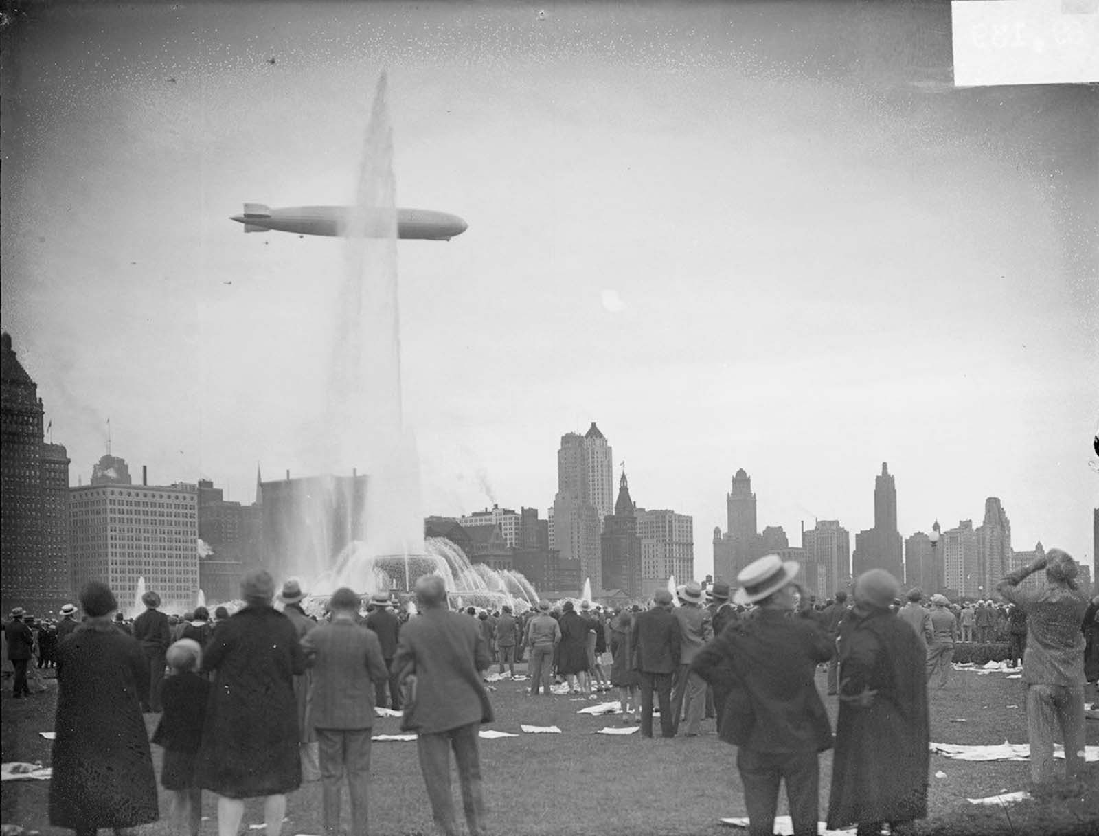 The Graf Zeppelin viewed in profile flying over Buckingham Fountain in Grant Park in the Loop community area of Chicago.