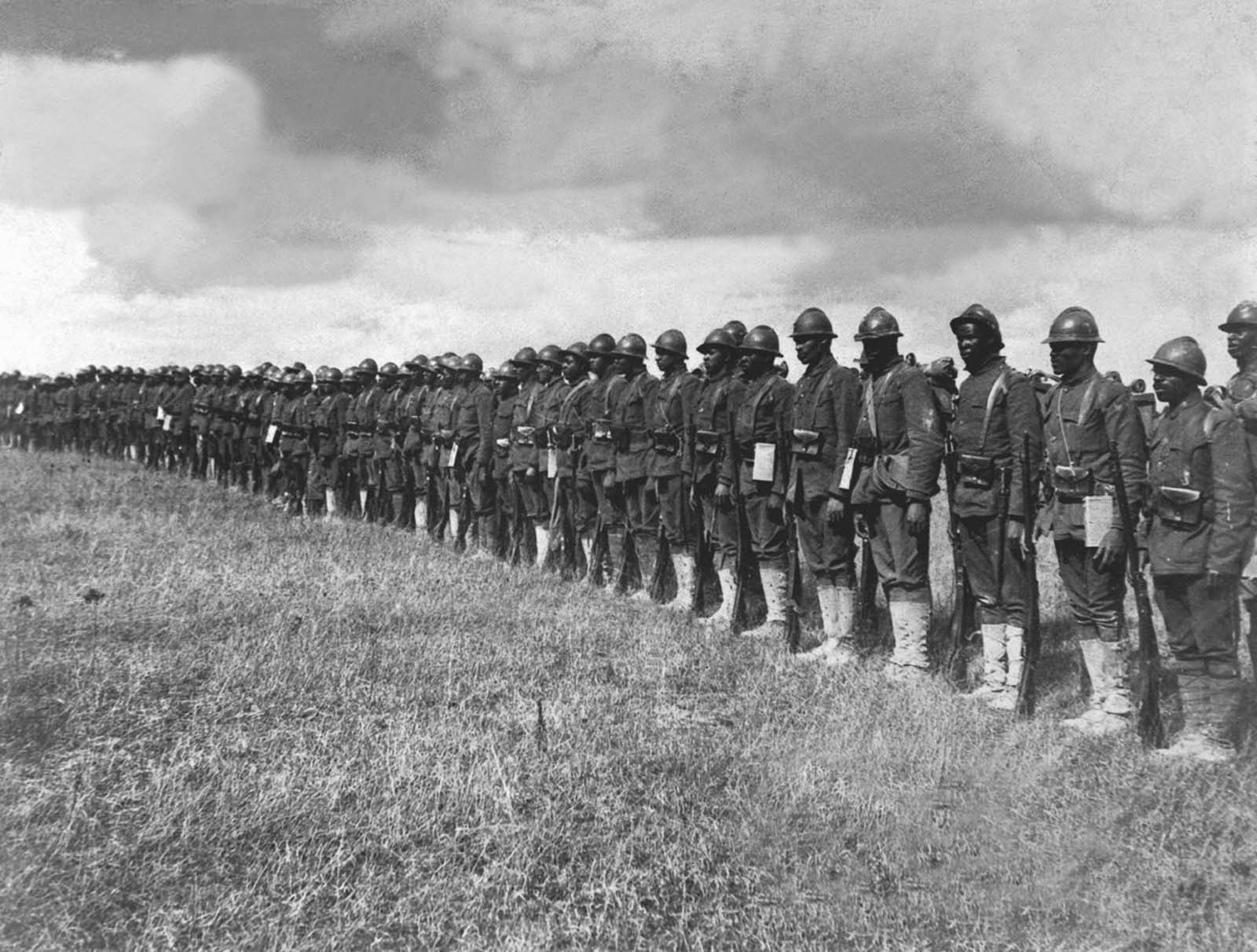 Soldiers of the 369th Infantry Regiment stand at attention.