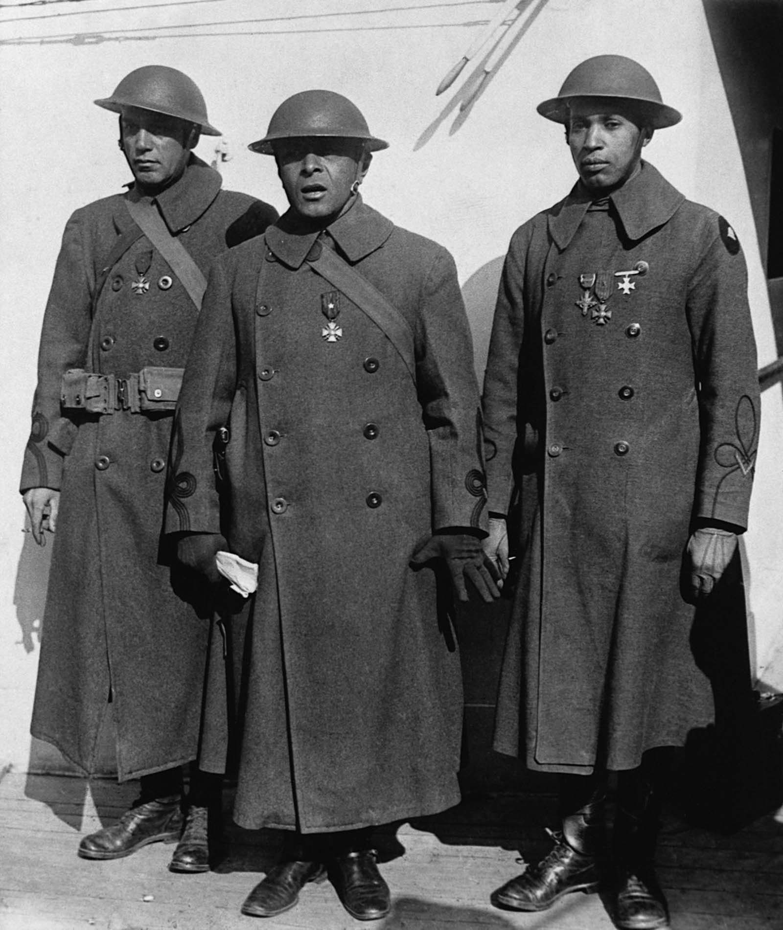 Officers of the 369th and 370th return home bearing the Cross of War medal.