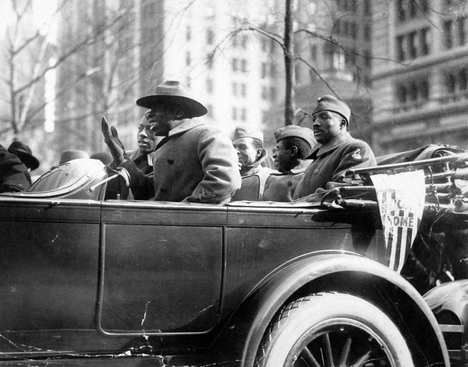 Wounded soldiers of the 369th ride in their victory parade.