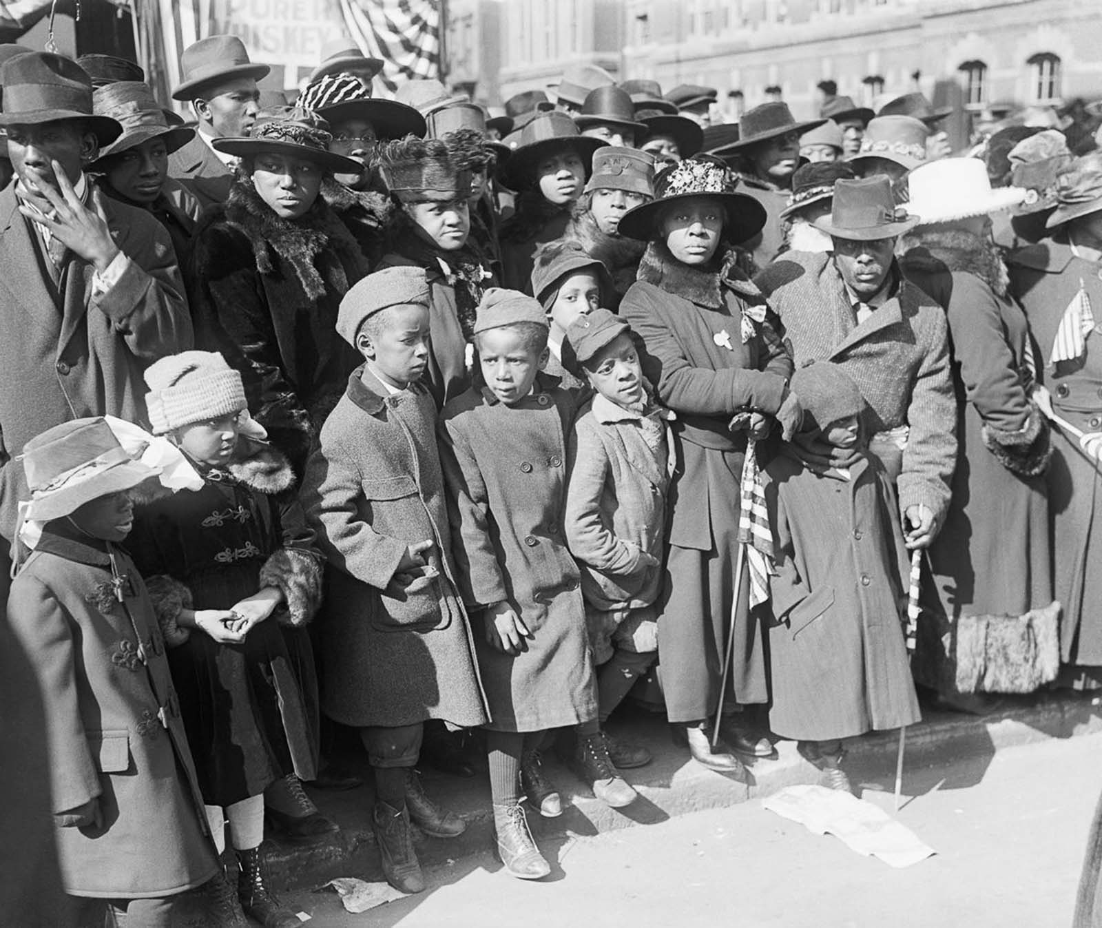 Spectators gather to watch the 369th on their return parade.