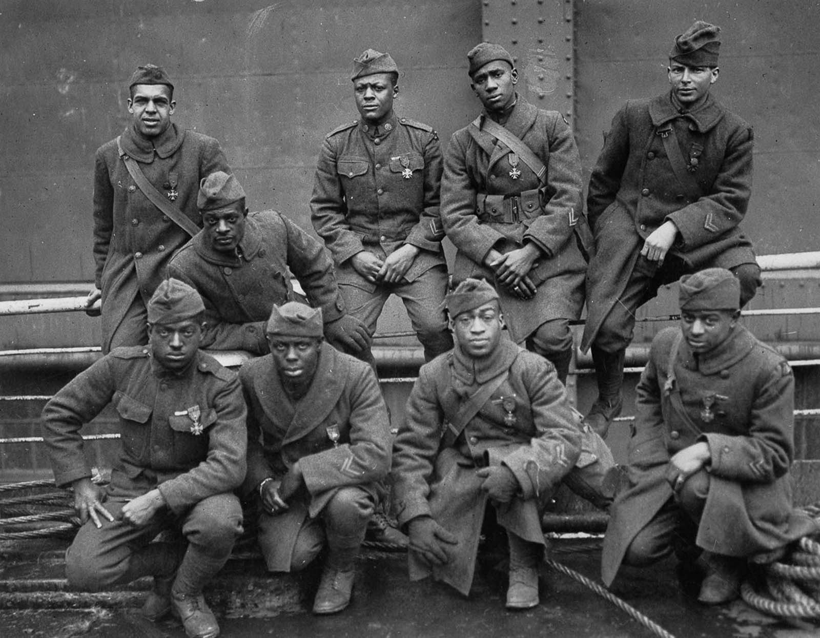 Soldiers of the 369th wearing the Cross of War medal pose for a photo on their trip back to New York.