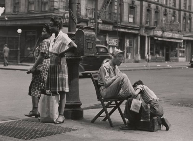 A soldier getting a shoe shine on 125th Street, 1946