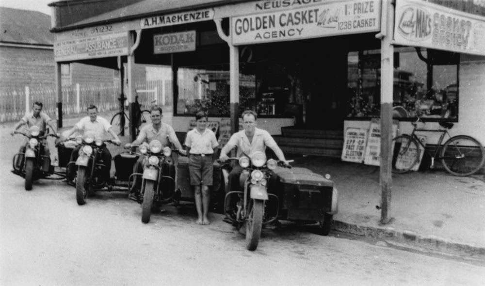 Harley Davidson motorbikes with sidecars outside Mackenzie's Newsagency, Bulimba, Brisbane, 1953