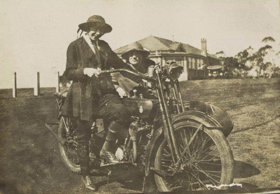 Two women posing with a motorbike and sidecar, 1922.