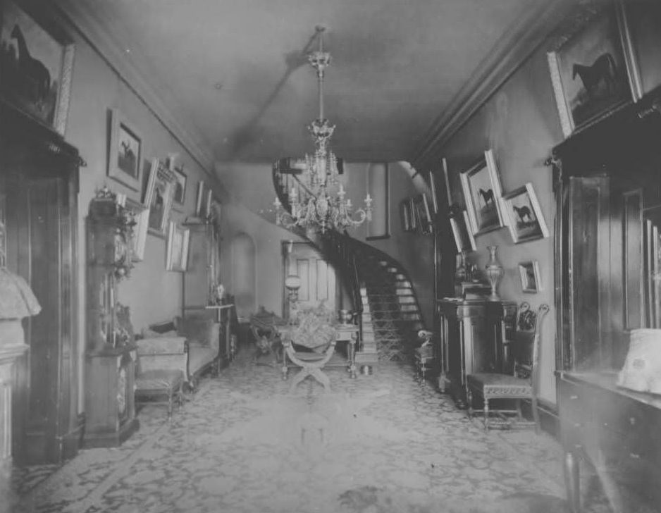 Interior view of Belle Meade Mansion hallway showing winding staircase, 1970s