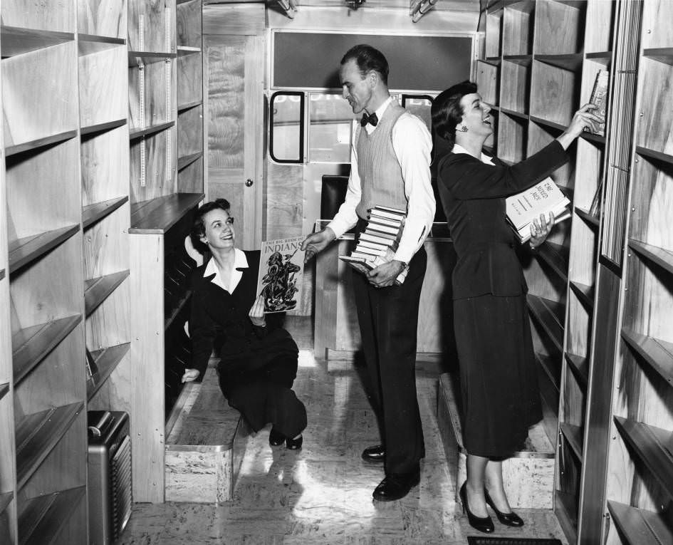 Nashville Public Library staff members shelving books in the bookmobile, 1955