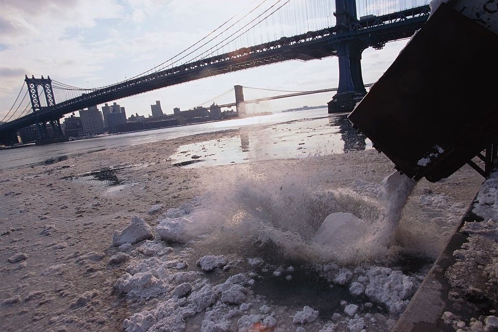 Bulldozer Dumping Snow in River