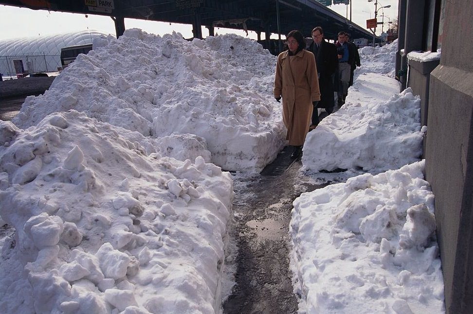 Mounds of Snow Lining City Sidewalk