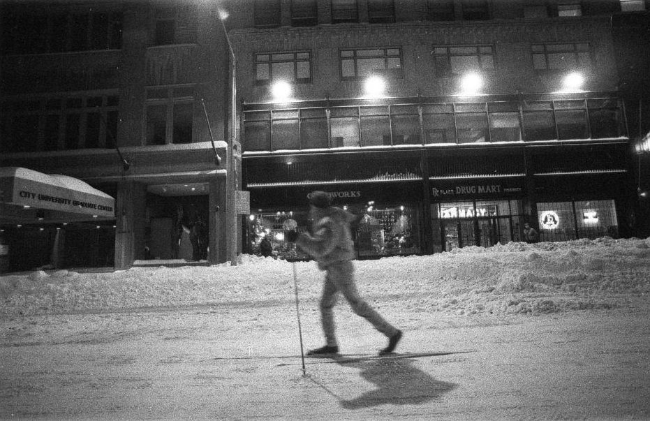 Woman cross country skiing on 42nd street during snow blizzard.