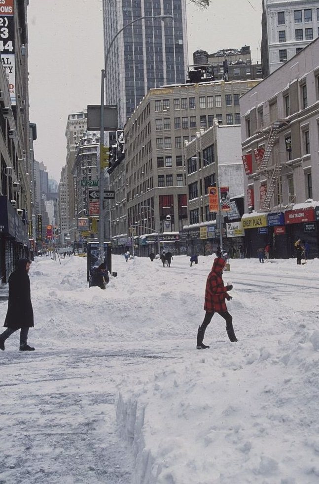 Pedestrians Walking Across Snow-Covered Street