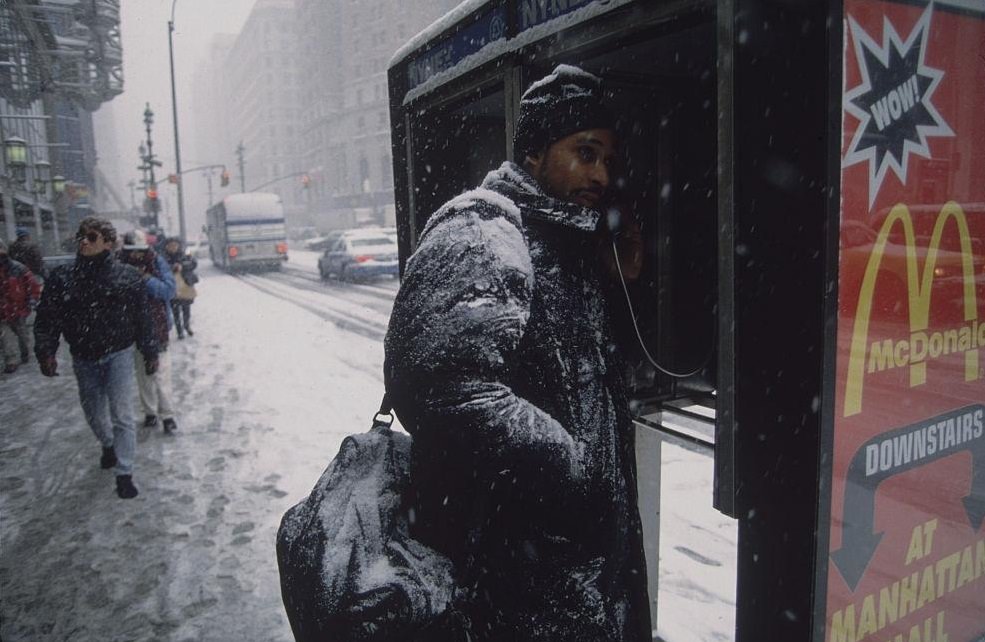 Man in Snow-Covered Coat Talking on Pay Phone, New York City, 1996