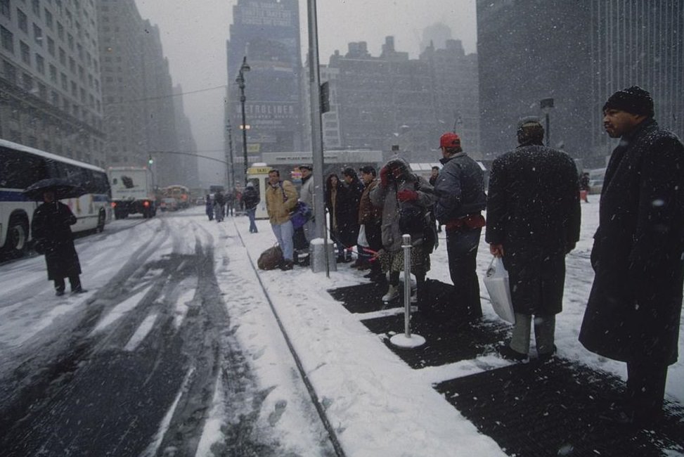 People Lining up on Street at Bus Stop in Snow, New York City, 1996