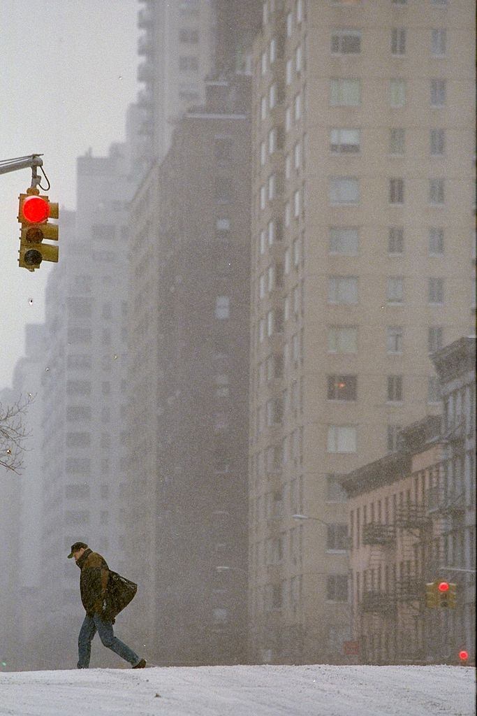 Pedestrian walks along a desolate First Ave. during a blizza