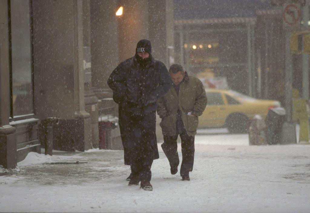Pedestrians slowly make their way up 57th St. during a blizzard, New York City, 1996