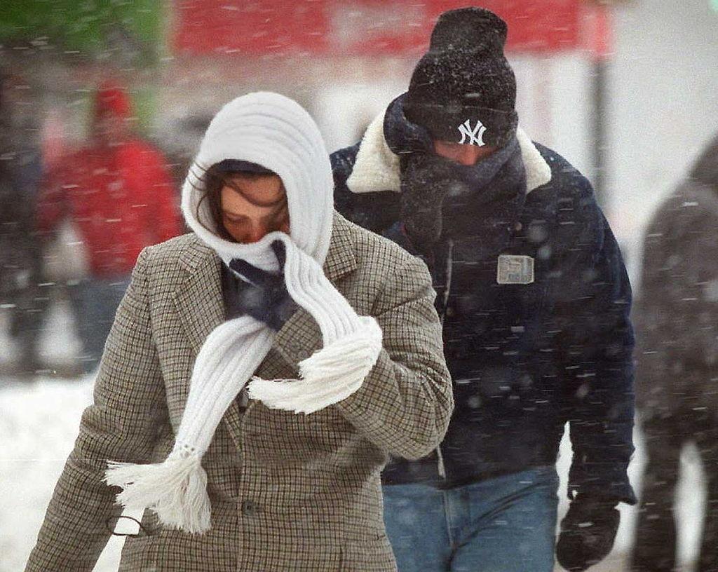 New Yorkers bundle up against blizzard conditions on the streets of New York City as a winter storm hits.